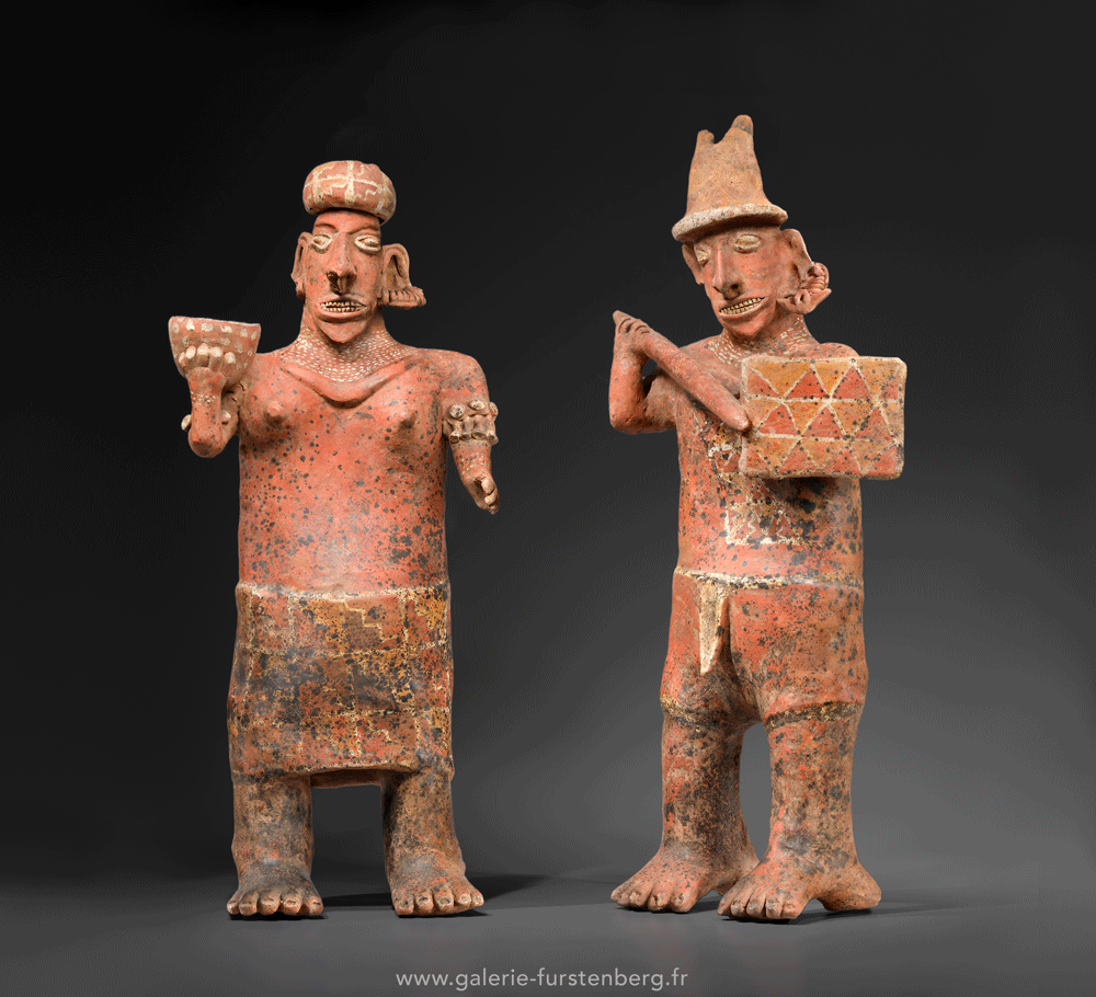 LARGE PAIR OF NAYARIT ANCESTOR FIGURES Red terracottas painted in beige and black Mexico, Nayarit culture, Ixtlan del Rio, 100 BC - 300 AD Heights: 71and 68 cm
